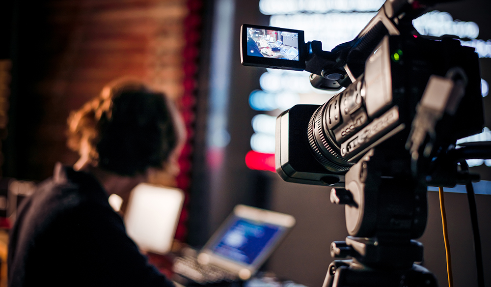 A candidate on their mobile phone, engaging with a company's video content on a social media platform like LinkedIn or Instagram.
